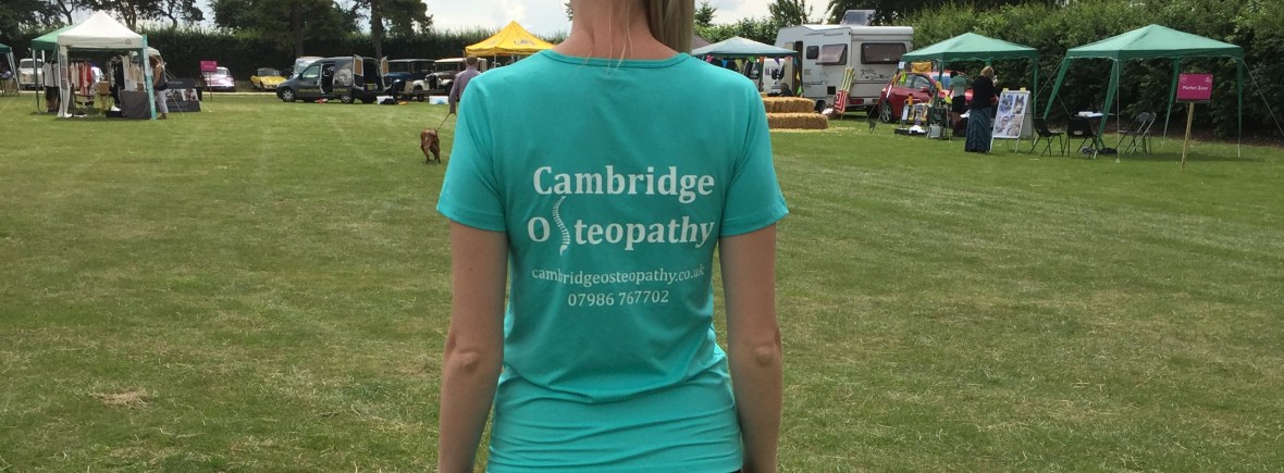 Image of a female wearing a "Cambridge Osteopathy" T-shirt showing the website and telephone number